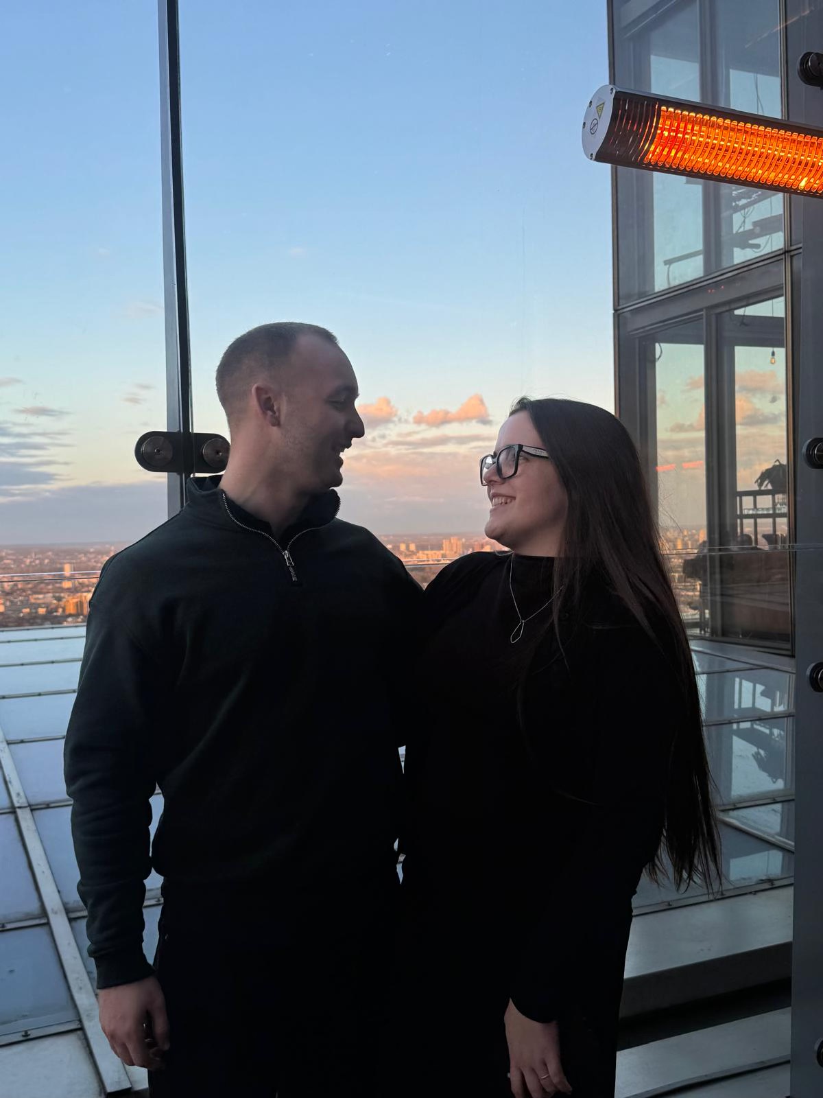 Claire and George together overlooking a city