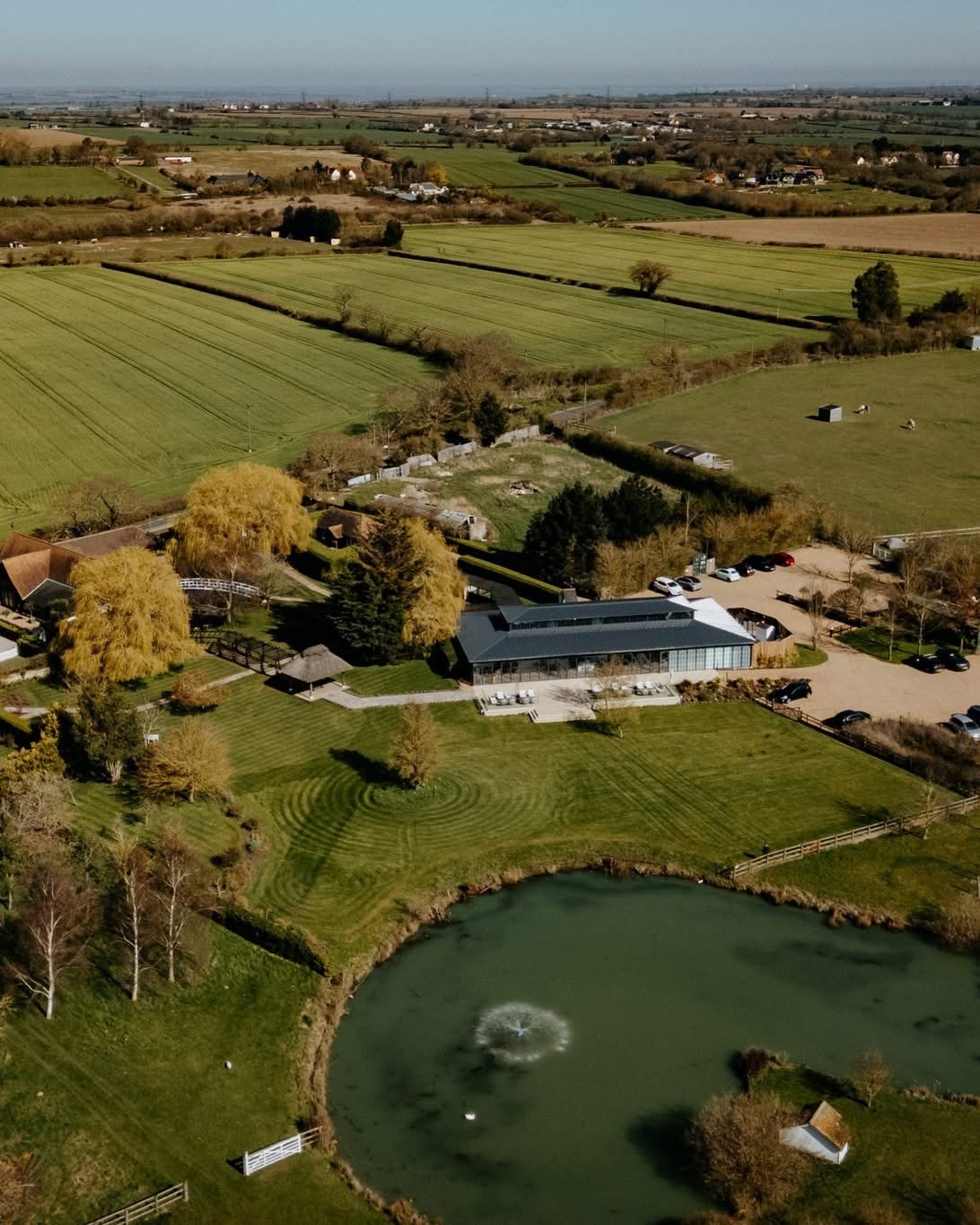 Aerial view of High House Weddings, its gardens and lake