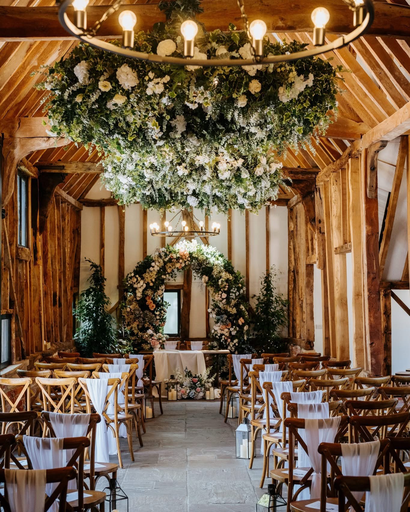 The timber-framed ceremony barn dressed with flowers