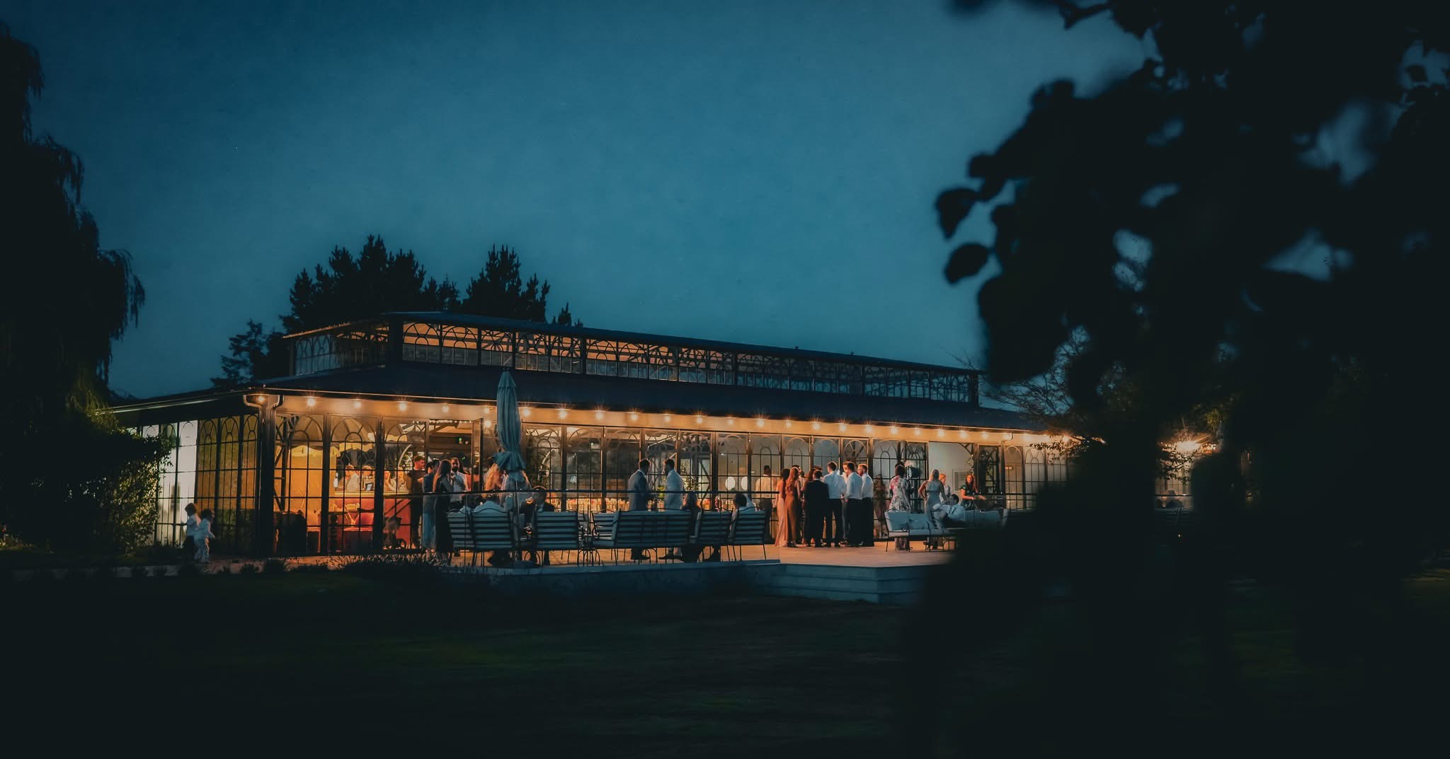 The Orangery glowing after dark as guests celebrate